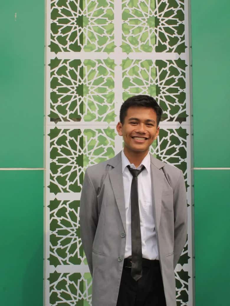 Rayyan Ahmad Bahy Rachmandika smiling in formal attire